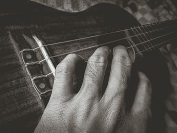 Close-up of man playing guitar