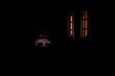 Man in dark room