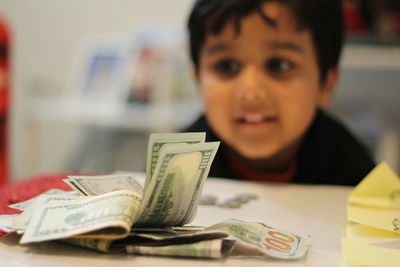 Boy looking at paper currencies