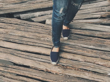 Low section of man standing on wood floor