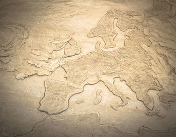 High angle view of text on sand