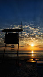 Silhouette of lifeguard tower with beautiful sunhine on the beach