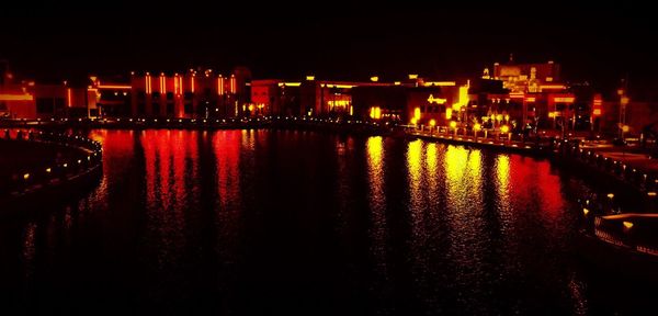 Illuminated city at waterfront