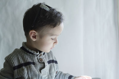 Close-up of boy looking away at home