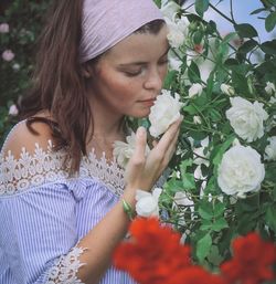 Young woman smelling flowers