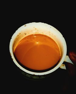 Close-up of coffee on table against black background