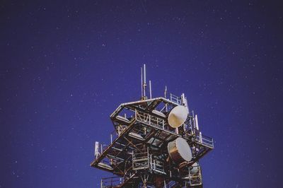 Low angle view of illuminated ferris wheel at night