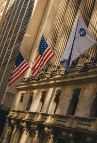 Low angle view of flags against building