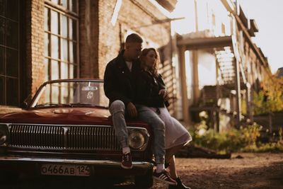 Man and woman standing on bus in city