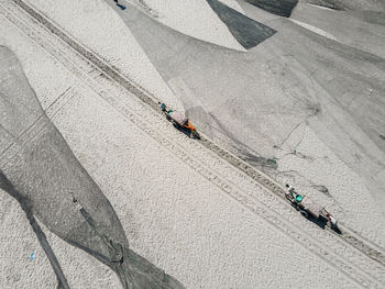 High angle view of people walking on beach
