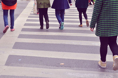 Low section of people walking on road