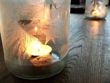 Close-up of illuminated candles on table