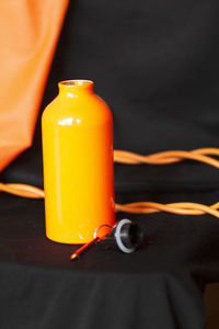 Close-up of yellow bottle on table