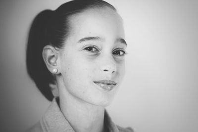 Close-up portrait of young woman over white background