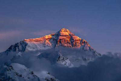 High angle view of snowcapped mountain against sky during winter