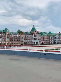 View of buildings against cloudy sky