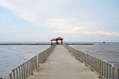 Gazebo on pier against sky