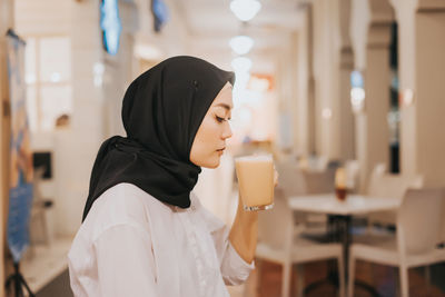 Portrait of a woman with drink