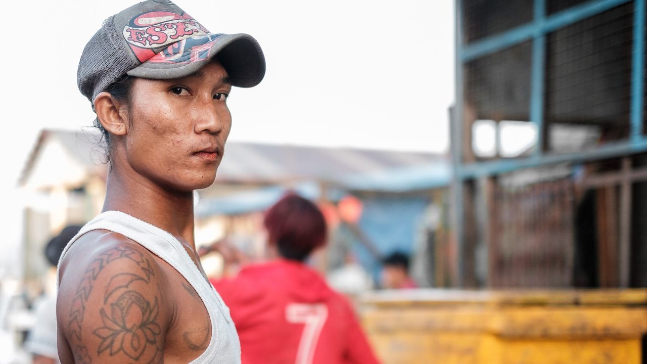 one person, headshot, focus on foreground, real people, portrait, day, young adult, young men, looking, cap, lifestyles, tattoo, looking away, men, leisure activity, architecture, incidental people, clothing, standing, contemplation, uniform