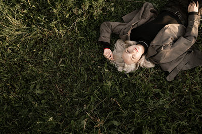 High angle view of girl lying on grass