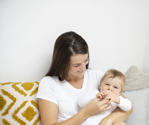 Mother and daughter against white background