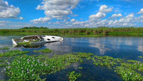 Abandoned boat in lake monroe against sky