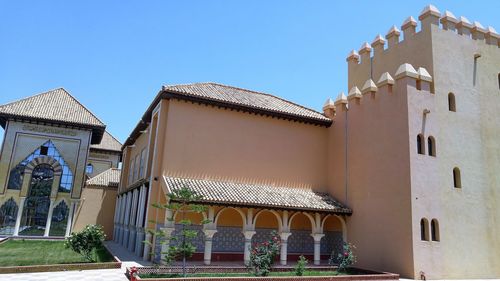 Low angle view of traditional building against clear blue sky