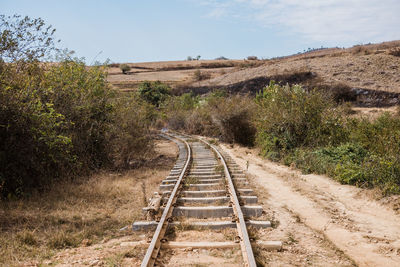 Railroad track amidst trees against sky