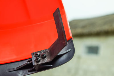 Close-up of coin-operated binoculars against orange sky