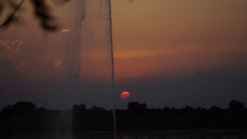 Scenic view of trees against sky during sunset