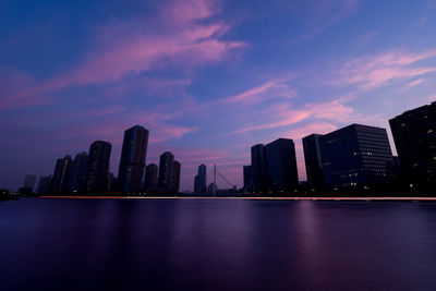 View of city at waterfront at night