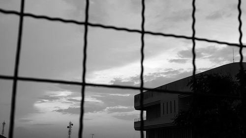 Low angle view of silhouette building against sky