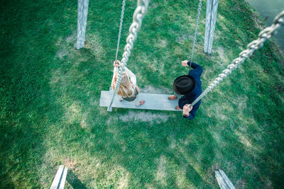 High angle view of people standing on swing