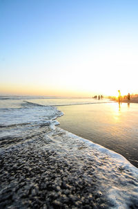Scenic view of sea against clear sky during sunset