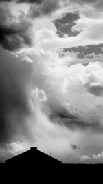 Silhouette of tree against cloudy sky