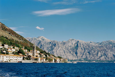 Scenic view of sea and mountains against sky