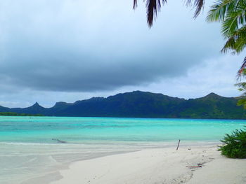 Scenic view of sea against cloudy sky