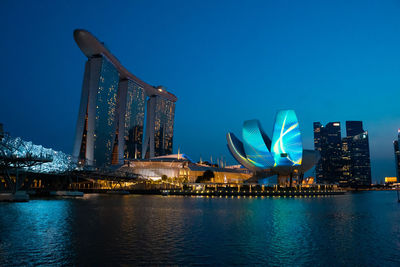 Illuminated modern buildings in city at night