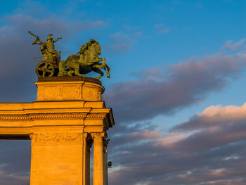 Low angle view of statue against cloudy sky