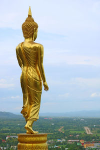 Nine metres high golden buddha image in wat phra that khao noi temple in nan province, thailand