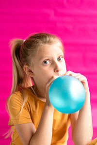 Portrait of a girl holding colorful balloons