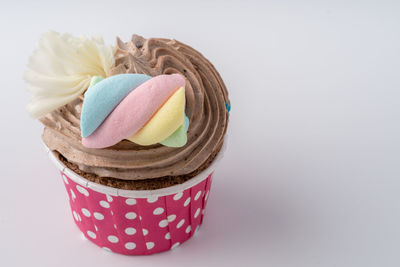 Close-up of multi colored cake against white background