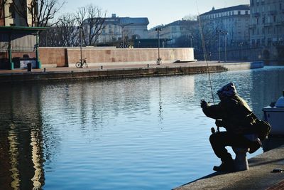 Man in city against sky