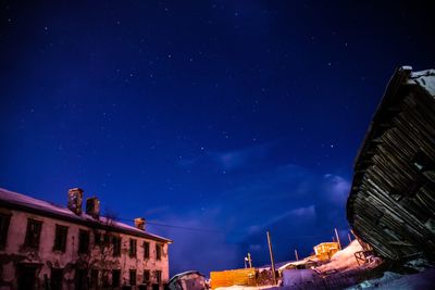 Low angle view of buildings against sky at night