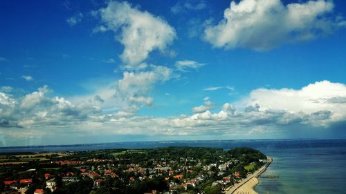 Aerial view of city against cloudy sky