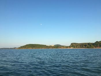Scenic view of sea against clear blue sky