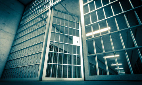 Low angle view of modern glass building against sky