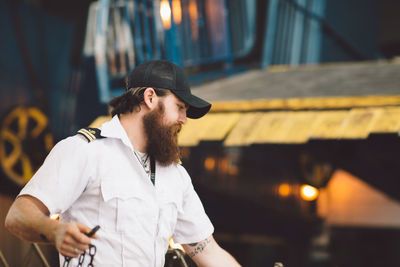 Man smoking while standing outdoors