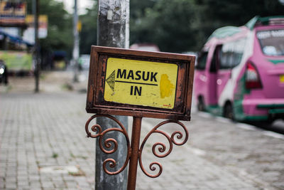 Close-up of information sign on street