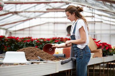 Woman standing in greenhouse